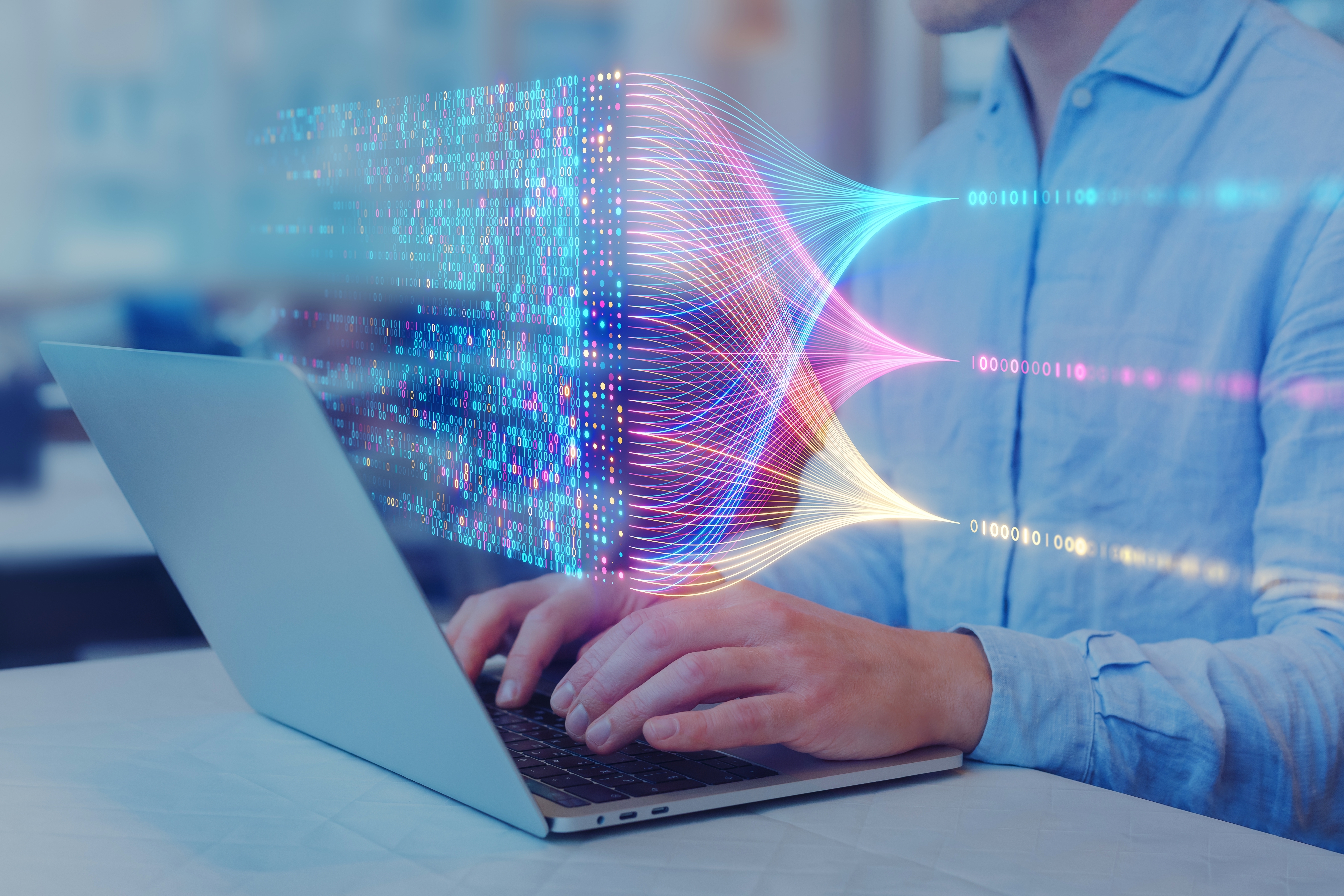 "Person using laptop with colorful data flow and binary code visualization"